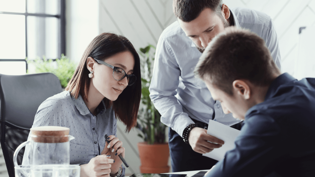 3 people looking at paperwork